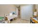 Neutral colored room with a white closet door, office supplies and white tables used for art production at 600 Buchannan Dr, Davenport, FL 33837