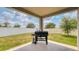 Undercover patio with grill, offering a perfect setting for outdoor cooking and entertaining in a spacious backyard at 600 Buchannan Dr, Davenport, FL 33837