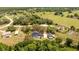 Spacious backyard and pool area of a well-maintained home with mature shade trees and greenery at 6917 Roman Ct, Clermont, FL 34714