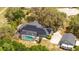 Home with solar panels, pool, screened enclosure, detached garage and an RV on the property at 6917 Roman Ct, Clermont, FL 34714