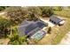 Home featuring solar panels, large pool with screened enclosure, and a detached garage at 6917 Roman Ct, Clermont, FL 34714
