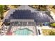 Stunning aerial view of home showcasing solar panels and screened-in pool area at 6917 Roman Ct, Clermont, FL 34714