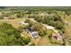 Aerial view of several homes and large lots with mature trees and landscaping at 6917 Roman Ct, Clermont, FL 34714