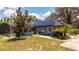 View of backyard with screened pool, solar panels, and patio area; perfect for outdoor living at 6917 Roman Ct, Clermont, FL 34714