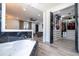 A luxurious bathroom features a soaking tub and a pass-through to a walk-in closet and a living area at 6917 Roman Ct, Clermont, FL 34714