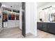 View from closet to ensuite bathroom featuring double vanity and private water closet at 6917 Roman Ct, Clermont, FL 34714