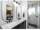 Modern bathroom featuring a double sink vanity with marble countertop, and a walk-in glass shower at 6917 Roman Ct, Clermont, FL 34714