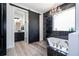 Luxurious bathroom featuring black and white marble, soaker tub and elegant sliding door at 6917 Roman Ct, Clermont, FL 34714