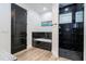 A modern bathroom features a walk-in shower with black tile at 6917 Roman Ct, Clermont, FL 34714