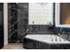 Stunning bathroom featuring elegant marble accents, soaker tub and unique window at 6917 Roman Ct, Clermont, FL 34714