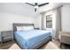A small bedroom is arranged with a modern ceiling fan, a full bed, and elegant grey curtains at 6917 Roman Ct, Clermont, FL 34714
