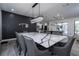 Spacious dining area connecting to kitchen, featuring a stylish table and modern lighting at 6917 Roman Ct, Clermont, FL 34714