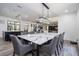 Open-concept dining and living space with a large dining table and elegant decor at 6917 Roman Ct, Clermont, FL 34714