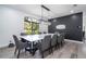 Elegant dining room featuring a large table, modern chandelier, and decorative wall accent at 6917 Roman Ct, Clermont, FL 34714
