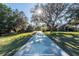 View down the driveway to home and additional play structure and outbuilding at 6917 Roman Ct, Clermont, FL 34714