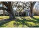 Charming single-story home with a well-maintained lawn and mature trees shading the property at 6917 Roman Ct, Clermont, FL 34714