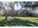 Exterior view of the home with mature trees, manicured lawn and updated facade at 6917 Roman Ct, Clermont, FL 34714