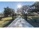 The property features a secure gated entrance, lush landscaping, and mature trees at 6917 Roman Ct, Clermont, FL 34714