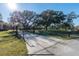 View of the property's gated entrance, a long driveway, and a mailbox with address at 6917 Roman Ct, Clermont, FL 34714