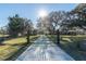 A long driveway leads to a gated entrance, ensuring privacy and security for the property at 6917 Roman Ct, Clermont, FL 34714