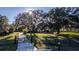 The property features a secure gated entrance, lush landscaping, and mature trees at 6917 Roman Ct, Clermont, FL 34714