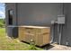 A Generac generator and A/C unit sit outside a modern home's exterior wall on a sunny day at 6917 Roman Ct, Clermont, FL 34714