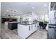 Open-concept kitchen with granite countertops, stainless steel appliances, and views of the dining and living areas at 6917 Roman Ct, Clermont, FL 34714