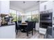 Cozy breakfast nook with a modern chandelier, table, and chairs next to a stainless steel oven and white cabinets at 6917 Roman Ct, Clermont, FL 34714