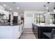 Modern kitchen with sleek black and white cabinets and an open view to other rooms at 6917 Roman Ct, Clermont, FL 34714