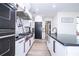 Contemporary kitchen features a gas range, black appliances, white cabinets, and granite countertops at 6917 Roman Ct, Clermont, FL 34714