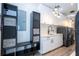 Modern laundry room featuring front load washer and dryer, white cabinets and stylish lighting at 6917 Roman Ct, Clermont, FL 34714