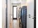 Modern laundry room with black washer and dryer, white cabinets, and hardwood floors at 6917 Roman Ct, Clermont, FL 34714