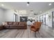 Open-concept living room features wood-look floors and an eat-in kitchen at 6917 Roman Ct, Clermont, FL 34714