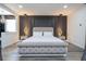 Spacious main bedroom featuring luxurious upholstered bed and decorative lighting at 6917 Roman Ct, Clermont, FL 34714