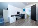 Bright, modern office space with sleek floors, black desk, filing cabinet, and view to next room at 6917 Roman Ct, Clermont, FL 34714