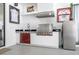 Covered outdoor kitchen with grill, sink, and beverage cooler, perfect for entertaining or enjoying outdoor meals at 6917 Roman Ct, Clermont, FL 34714
