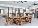 Outdoor dining area with a large table, seating, and a well-equipped outdoor kitchen on the covered patio at 6917 Roman Ct, Clermont, FL 34714