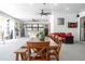 Large covered patio with dining table, lounge seating, and views of the outdoor pool area at 6917 Roman Ct, Clermont, FL 34714