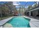Relaxing screened-in pool with ample deck space, lounge chairs, and an outdoor entertaining area at 6917 Roman Ct, Clermont, FL 34714