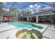 Spacious screened-in pool and spa with an expansive deck and outdoor living area, perfect for entertaining at 6917 Roman Ct, Clermont, FL 34714