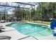 Gorgeous screened-in pool featuring a built-in hot tub and a fun basketball hoop for outdoor enjoyment at 6917 Roman Ct, Clermont, FL 34714