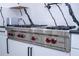 Close-up of a stainless steel Wolf gas range with red knobs and granite countertops at 6917 Roman Ct, Clermont, FL 34714