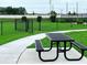 Community picnic area with a sturdy black table and benches, ideal for residents to enjoy outdoor meals at 730 Ginger Dr, Haines City, FL 33844