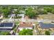 The home is surrounded by lush greenery, offering a serene escape with mature trees, nearby street views, and community feel at 7974 Village Green Rd, Orlando, FL 32818