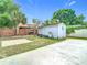 Backyard featuring a shed, fence, and a concrete patio at 7974 Village Green Rd, Orlando, FL 32818
