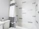 Bathtub and shower with stylish tile and a modern shower curtain at 7974 Village Green Rd, Orlando, FL 32818