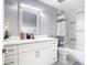 Bathroom with a modern vanity, large mirror, and shower with stylish tile at 7974 Village Green Rd, Orlando, FL 32818