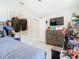 Bedroom with closet, tv, and modern decor at 7974 Village Green Rd, Orlando, FL 32818