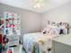Cozy bedroom with a ceiling fan, brightly decorated and full of character at 7974 Village Green Rd, Orlando, FL 32818