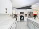 Bright, modern kitchen with white cabinets, stainless steel appliances, and sleek quartz countertops at 7974 Village Green Rd, Orlando, FL 32818